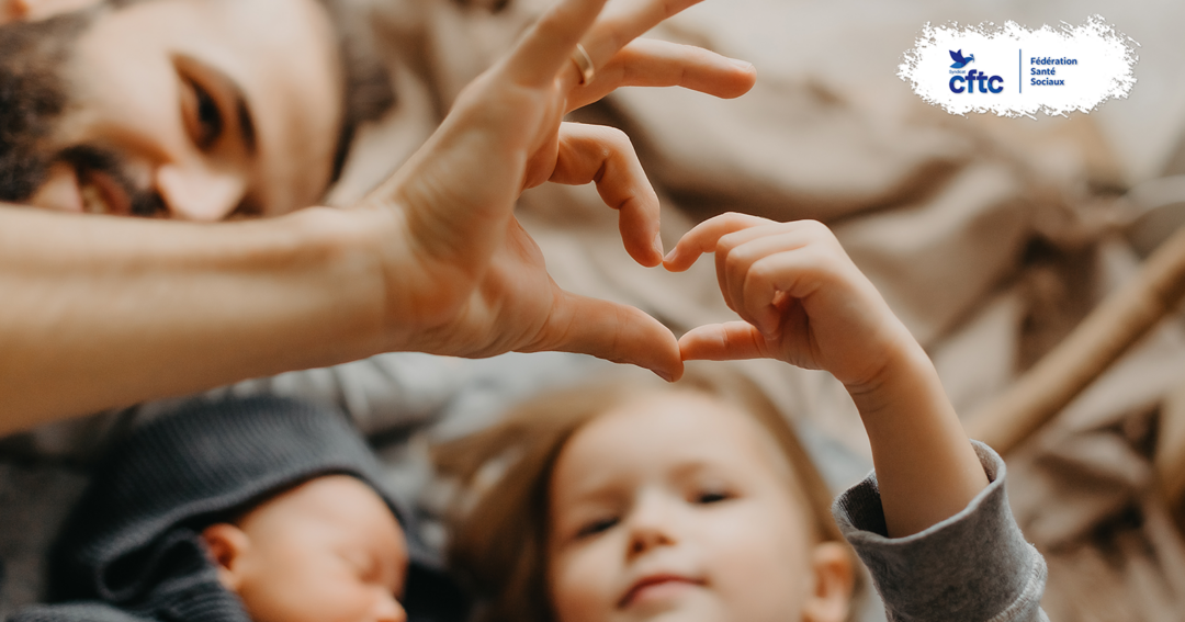 Une famille réunie forme un cœur avec ses mains, symbole de la parentalité et de la conciliation entre vie familiale et vie professionnelle.